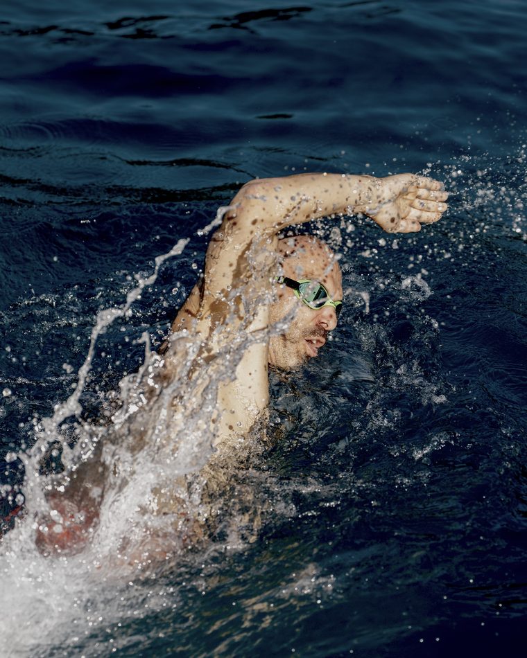 A swimmer mid-stroke in open water