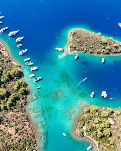 Yaz Limanı from the air, boats in a turquoise inlet