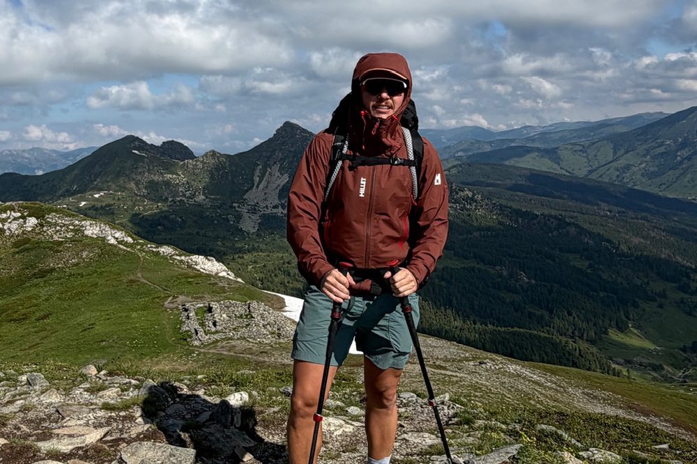 Kaan on a ridge with trekking poles